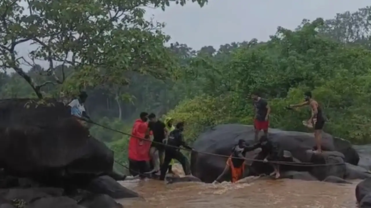 Tourists risk lives at waterfall during rains; locals’ quick action prevents disaster - News Karnataka
