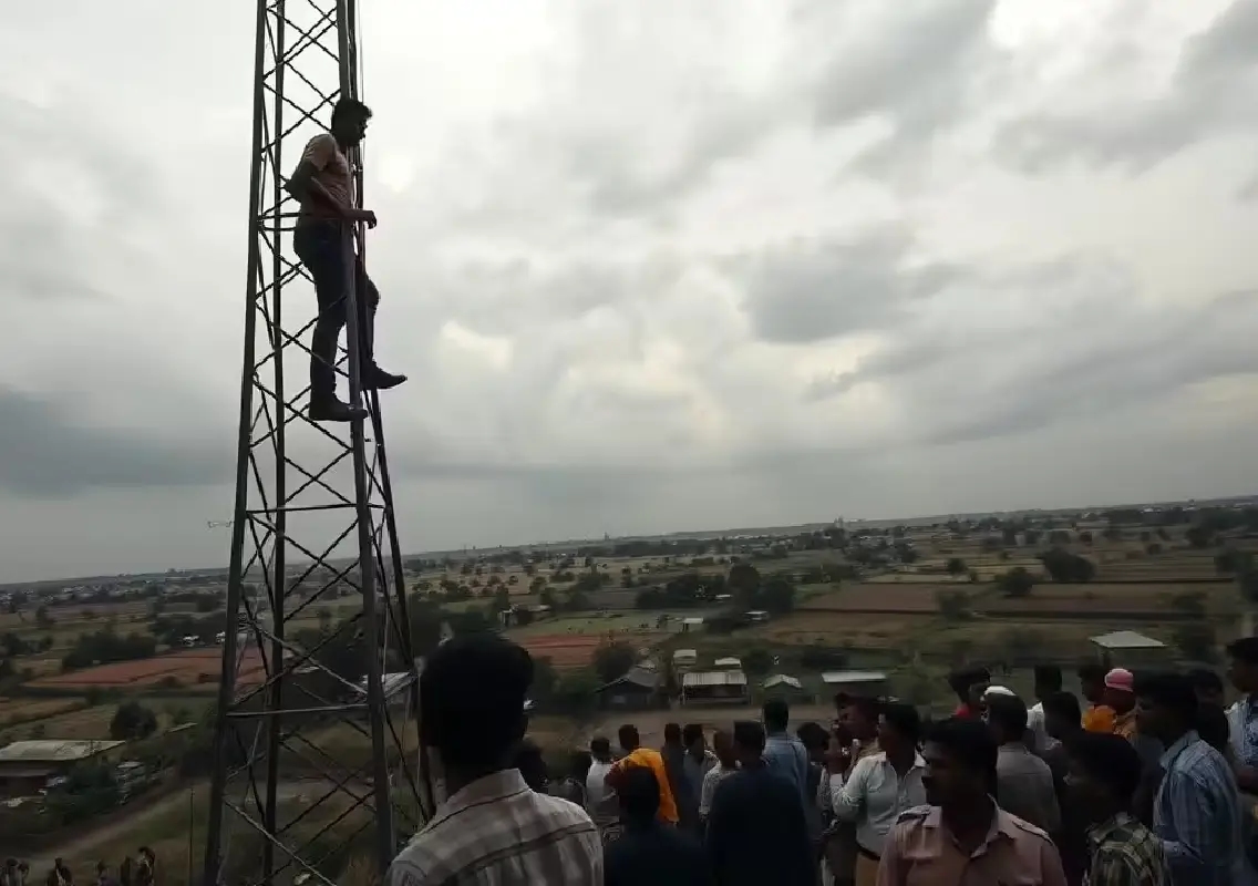 High drama as man climbs tower, demands DC at spot - News Karnataka