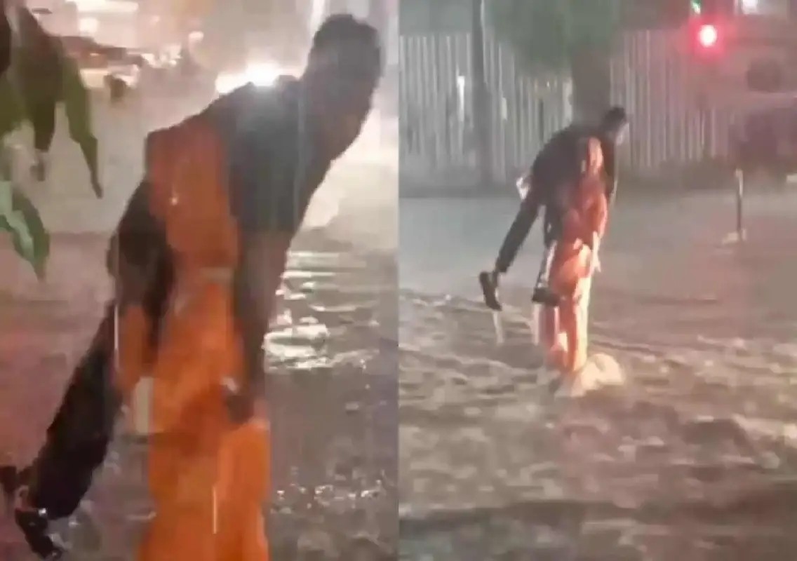 Bengaluru constable carries differently-abled youth across flooded road: WATCH - News Karnataka