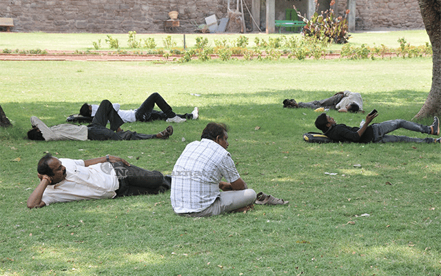 Men resting under tree shade, Vijayapura