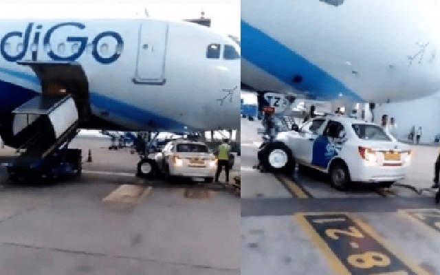 Car stops under parked IndiGo aircraft