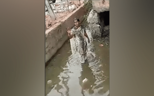 Woman stands in dirty nallah to protest after failing to meet K'taka minister